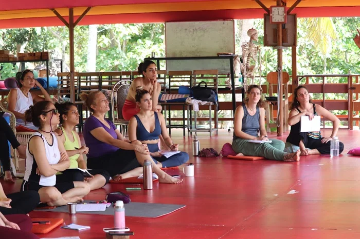 Focused yoga students attending a class at Rishikul Yogshala Focused yoga students attending a class at Rishikul Yogshala
