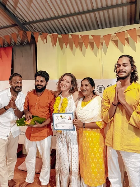 Yoga student celebrating YTTC Completion With Teachers at Rishikul Yogshala