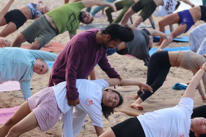 Instructor Guiding a Student Through a Side Bend Pose During the Advanced Yoga Adjustment and Alignment Course at Rishikul Yogshala