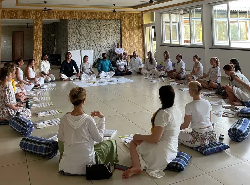 Yoga Retreat Students at Rishikul Yogshala in Goa, Sitting in a Circle for a Spiritual Ceremony