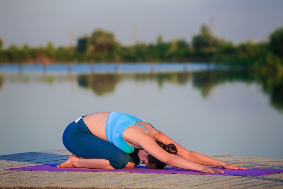 Woman Performing Child Pose (Balasana)
