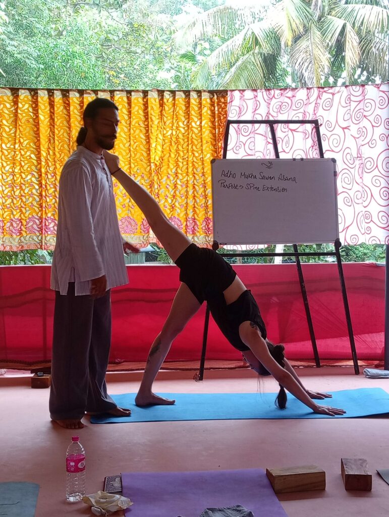 A yoga teacher sharing practical knowledge during a Yoga Teacher Training Course (YTTC) session