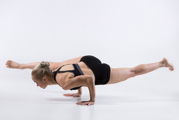 Woman Performing Eka Pada Koundinyasana
