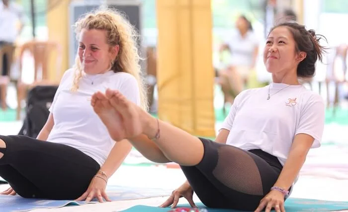 Group Yoga Practice - Building Strength and Flexibility Together Two women practicing yoga and core strengthening exercises