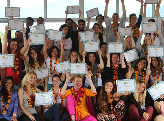 Yoga Teacher Training Graduation Celebration at Rishikul Yogshala Group of yoga teacher training graduates celebrating with certificates at Rishikul Yogshala