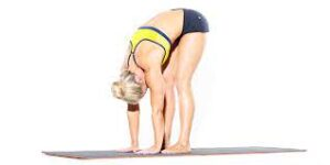 Uttanasana (Forward Bend) Yoga Pose – Flexibility and Relaxation Woman performing a standing forward bend yoga pose