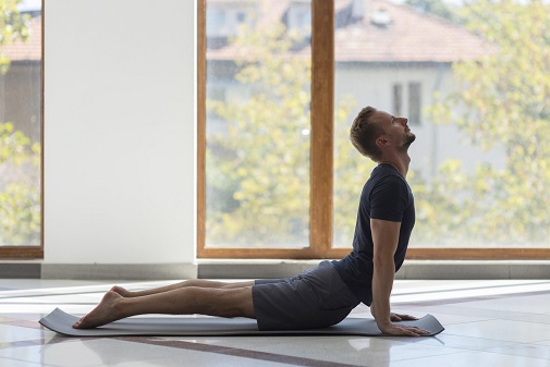 Man Practicing Bhujangasana (Cobra Pose)