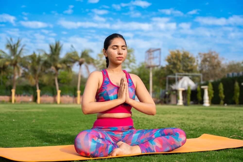 Woman Practicing Yoga Outdoors in a Peaceful Park | Meditation & Wellness Woman Practicing Yoga Outdoors in a World Yoga Day | Meditation & Wellness