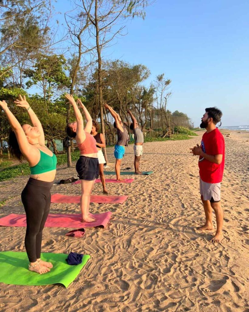 Students Practicing Yoga at The Beach 
