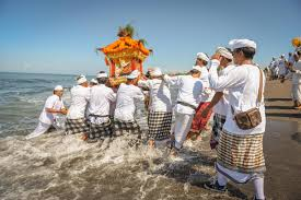 Melasti Ritual - Balinese Hindu Purification Ceremony Before Nyepi Balinese ceremony with devotees in traditional