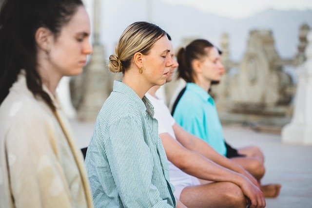 What is Bhakti Yoga? A Heartfelt Path of Love, Prayer, and Kindness 1 Women doing Bhakti Yoga and Sadhana