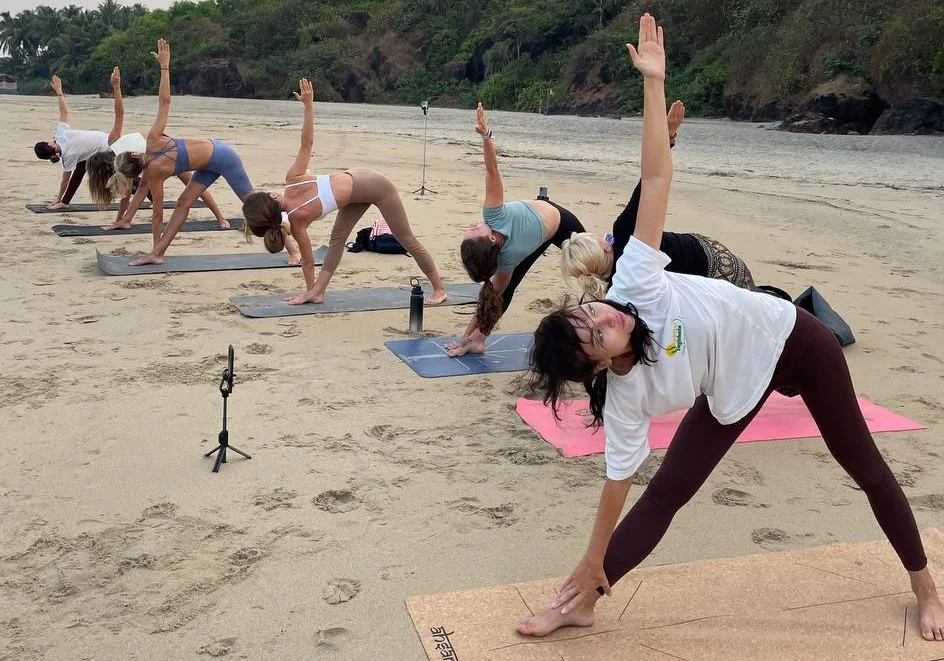 Group of People Performing Yoga Near Beach in Mysore at Rishikul Yogshala
